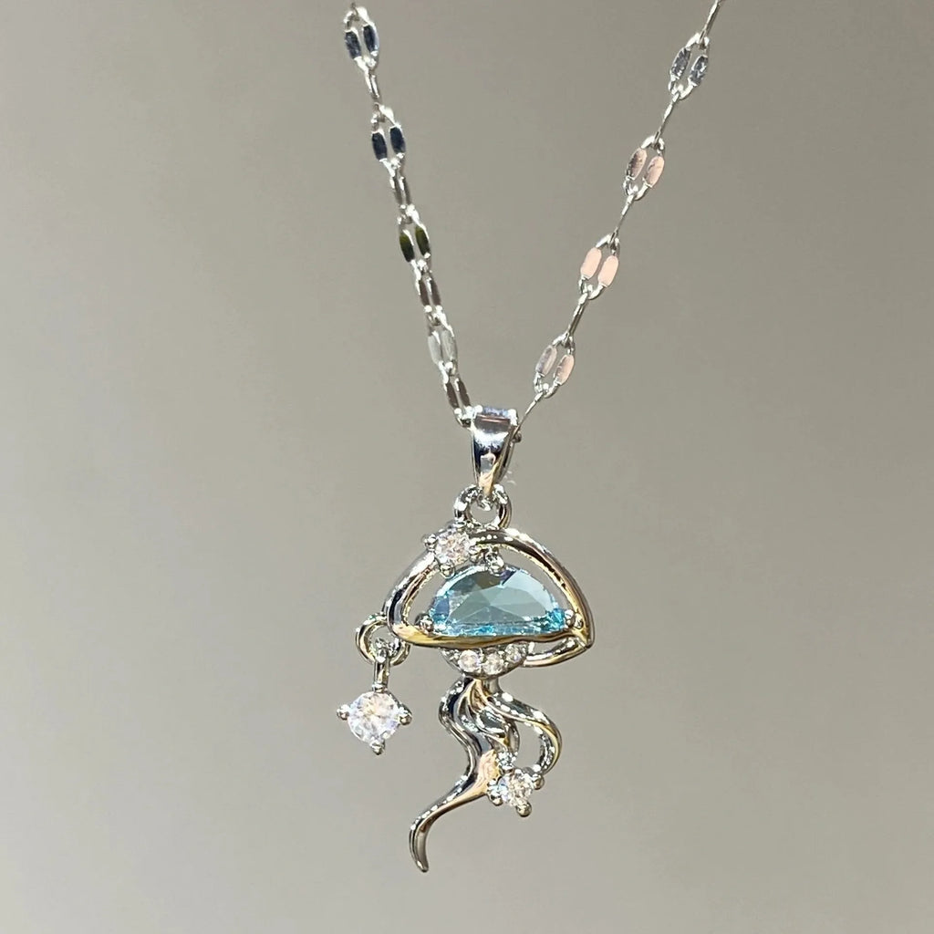 Blue jellyfish pendant on a white gold coloured adjustable sterling silver necklace chain.