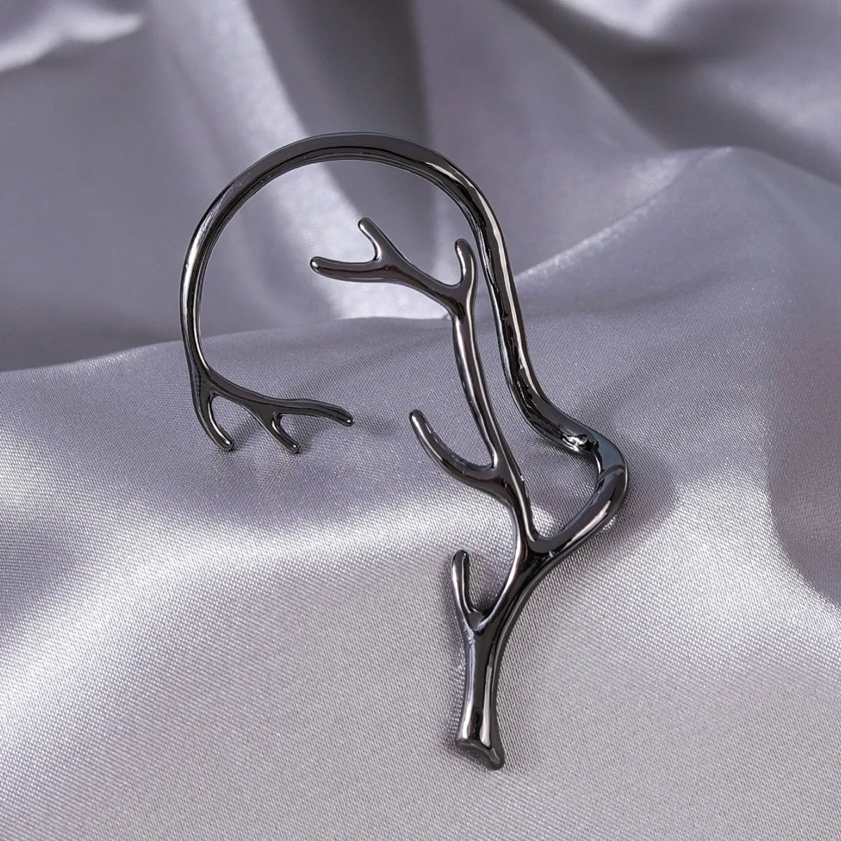 Vintage bone hypoallergenic elf earrings in gold, silver, black, and green with geometric design