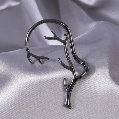 Vintage bone hypoallergenic elf earrings in gold, silver, black, and green with geometric design