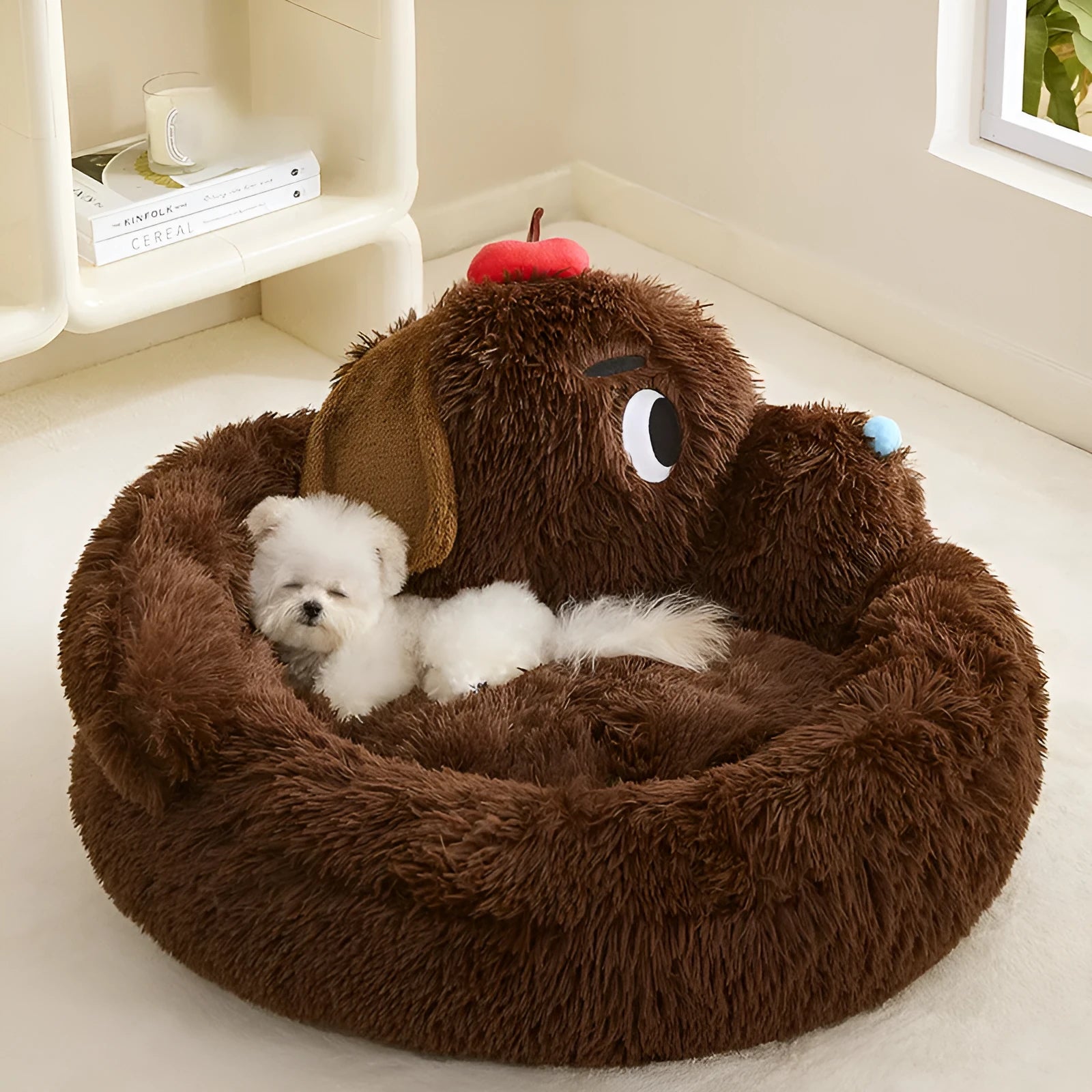 A grey plush sofa-style pet bed with high bolsters on three sides, shown in two sizes.