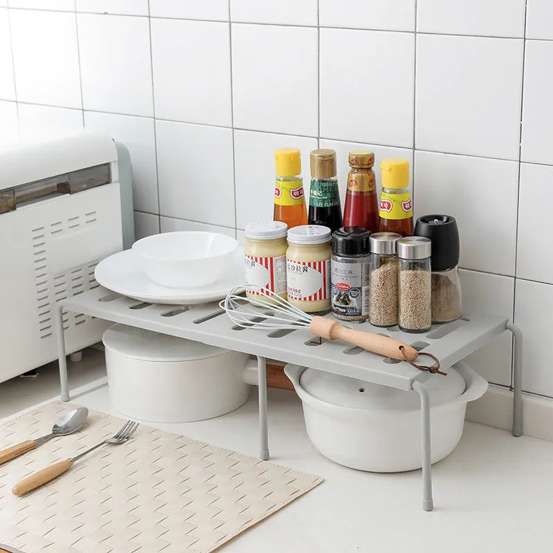 White telescopic plastic kitchen rack at extended height with ground installation
