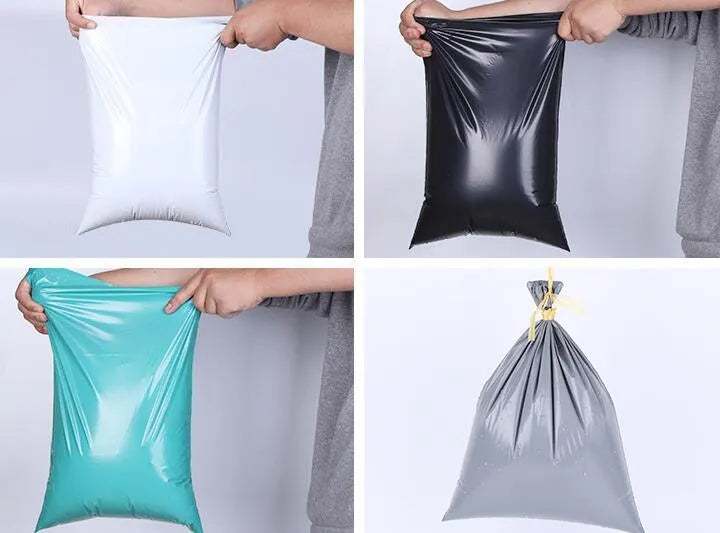 Bundle of 100 clear plastic courier clothing bags in multiple sizes with adhesive closure stickers.