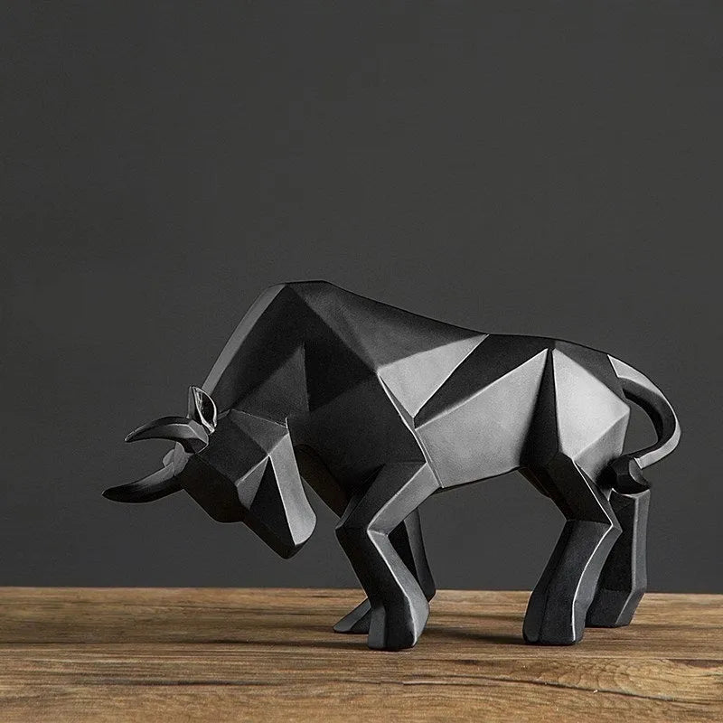 Modern geometric resin bull sculpture in black with abstract angular design on a neutral background