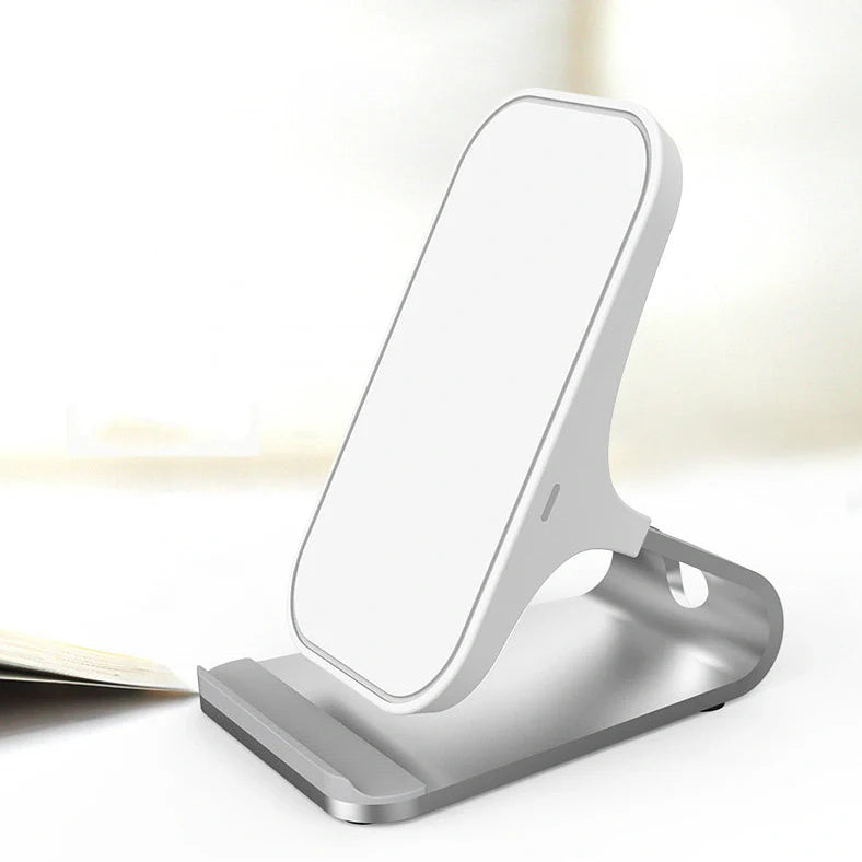 Black wireless charging pad with smartphone positioned vertically on metal surface