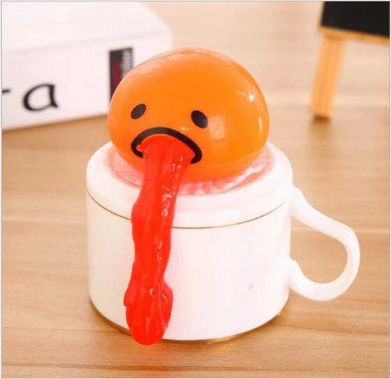 Gudetama Vomiting Egg Toy in green, orange, pink, and yellow