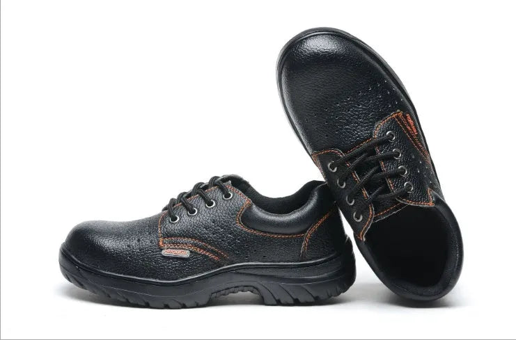 Black embossed cowhide safety shoes with steel toe cap and antiskid outsole on concrete floor