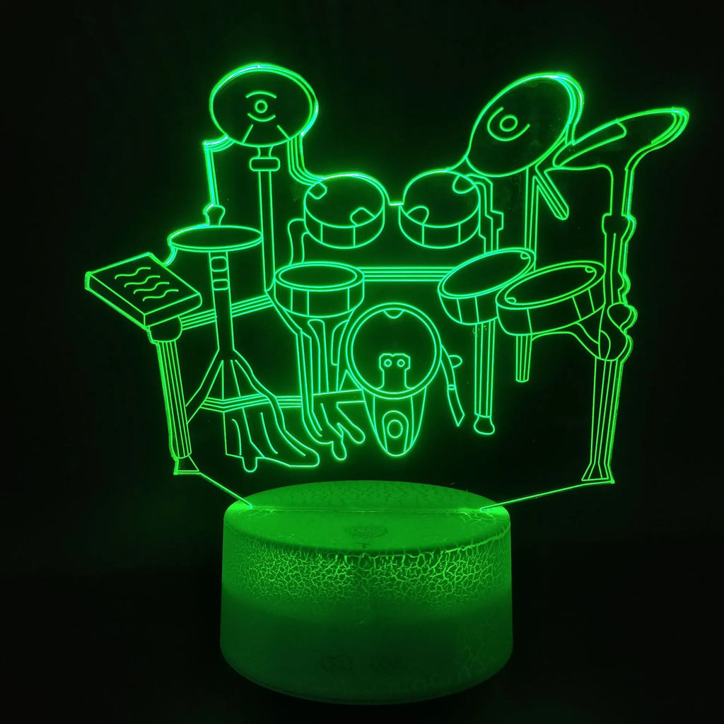 3D acrylic drum kit night light showing seven colour LED illumination on a desk