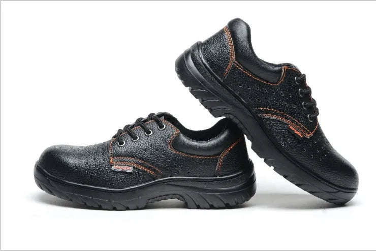 Black embossed cowhide safety shoes with steel toe cap and antiskid outsole on concrete floor