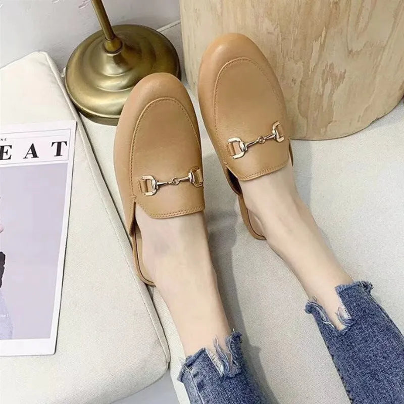 Women's PVC closed toe half slippers shown in milky white colour with a double buckle fastener.
