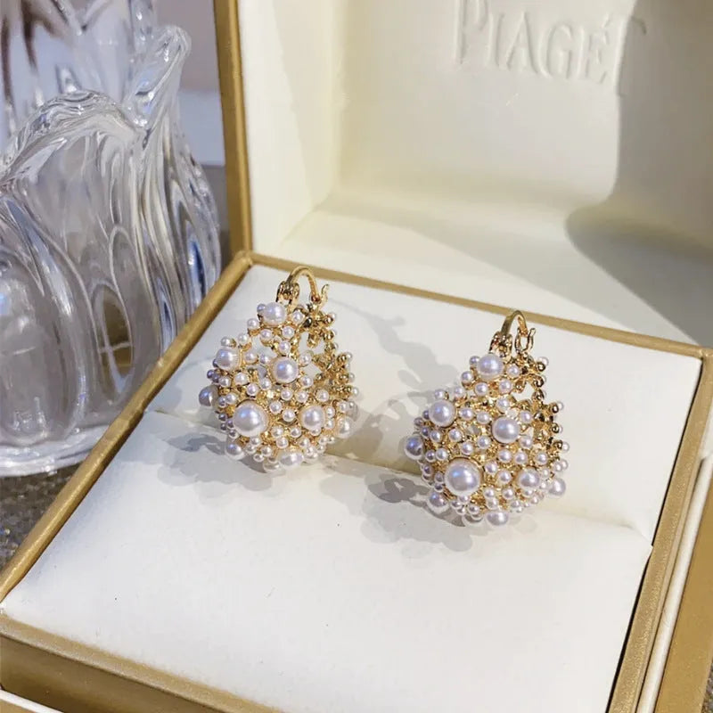 Gold-coloured copper flower basket earrings with small rice-shaped beads and pearl inlay details