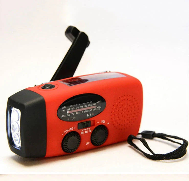 Red solar hand crank USB charging radio flashlight with AM/FM radio and LED light