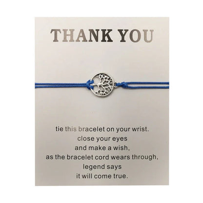 Hand-woven red rope Tree of Life bracelet with adjustable sizing