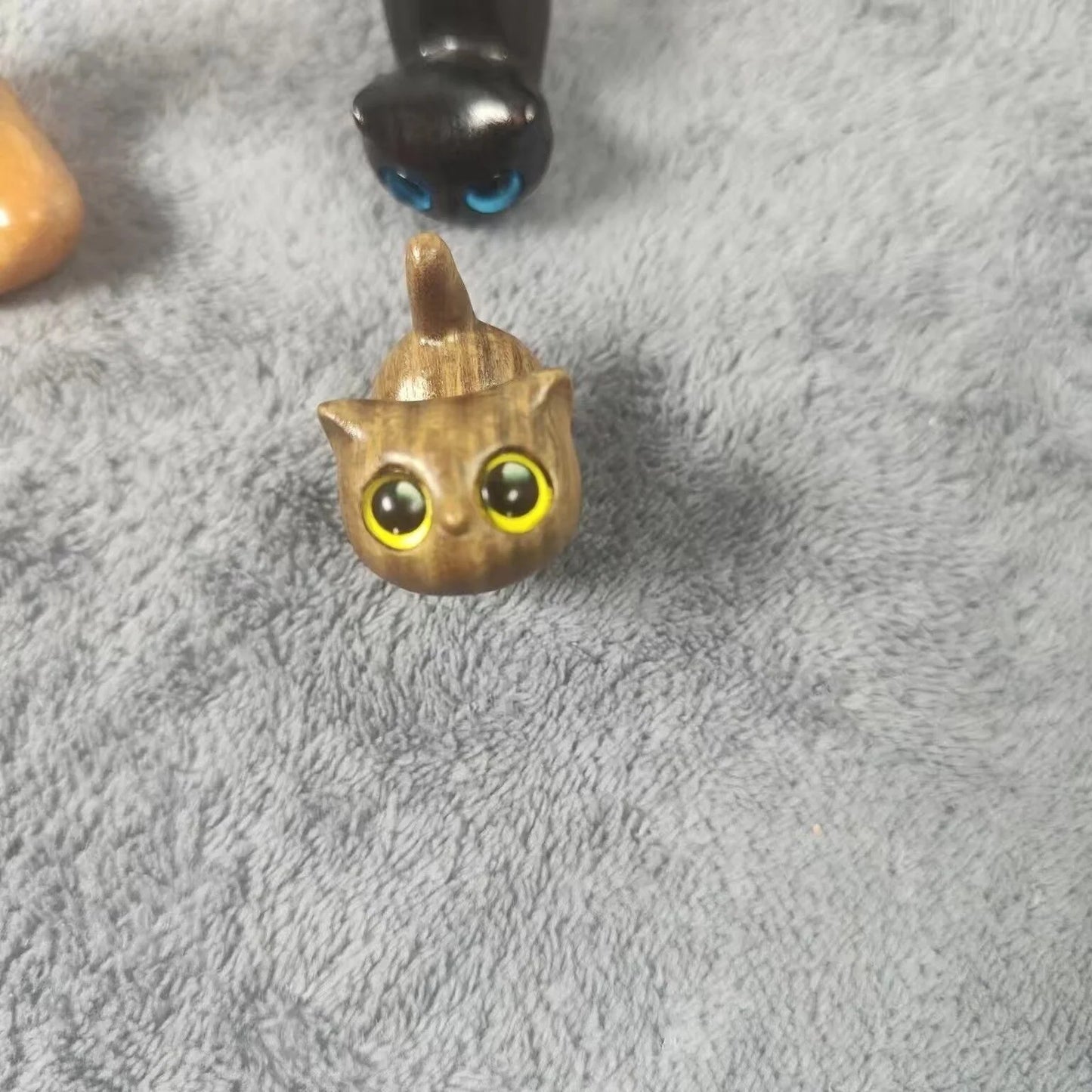 Handcrafted sandalwood kitten ornaments in various styles and colours