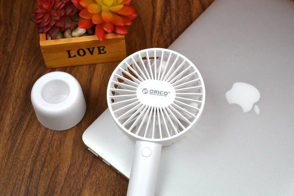 White ORICO FH1 portable USB rechargeable desk fan with three-speed buttons and a fine line pattern on its ABS shell.