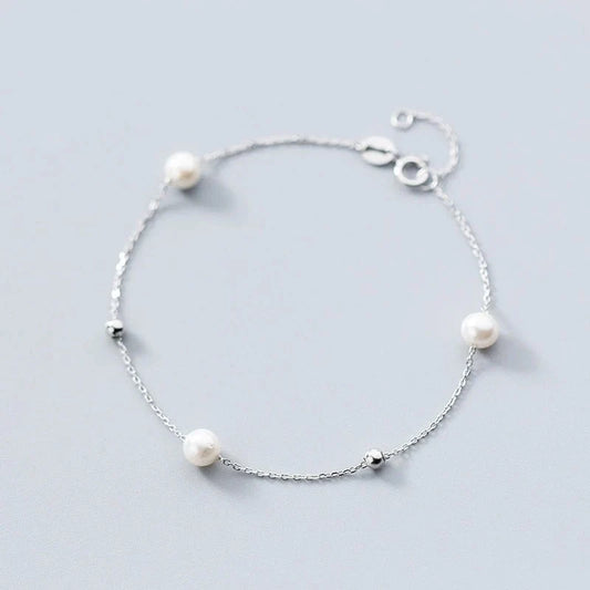 Adjustable synthetic pearl bracelet with 925 silver clasp, perfect for any wrist size