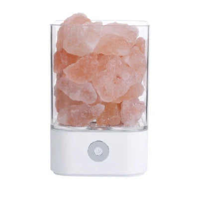 Himalayan salt lamp with natural pink-orange glow, releasing negative ions to purify the air and create a calming, relaxing atmosphere