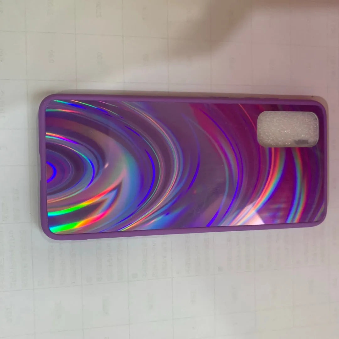 Marble pattern silicone phone case for Samsung Galaxy smartphone on a table.