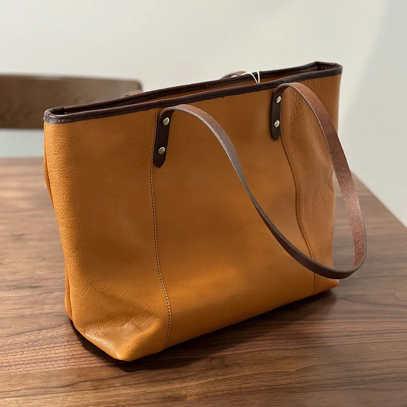 Horizontal square first-layer cowhide leather single-shoulder bag in brown with sewing thread detail and multiple pockets