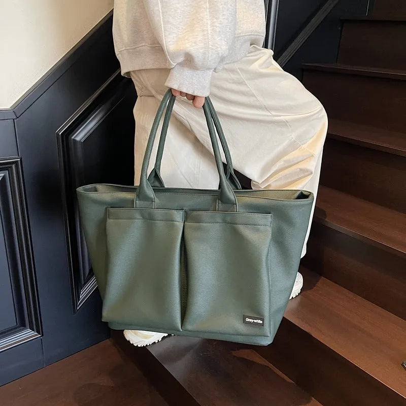 Lightweight sporty shoulder bag in PU material, shown in green colour