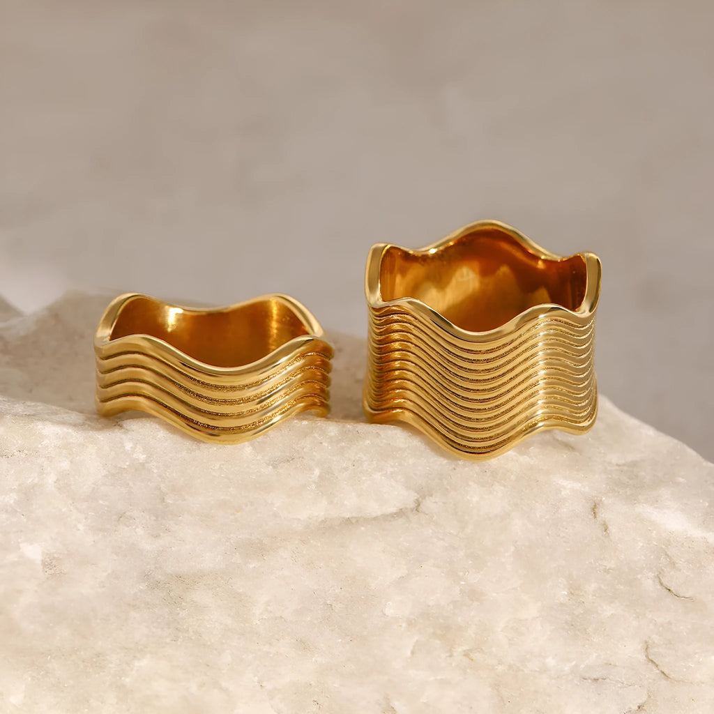 Geometric wave pattern on a stainless steel wide band ring in an electroplated colour finish.