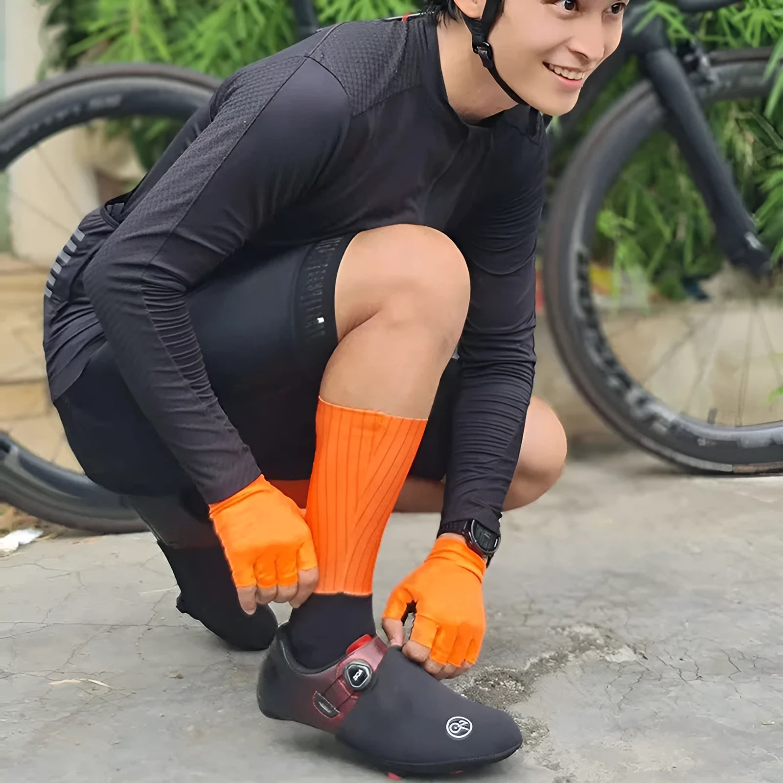 Cycling and running socks in chemical fibre blend fabric shown in orange, black, purple, white, grey, and dark blue colours.