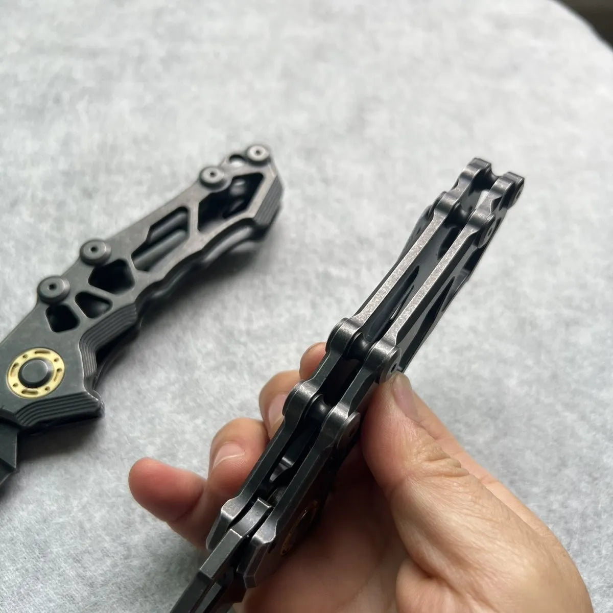 D2 steel folding knife with 9cm blade on outdoor background