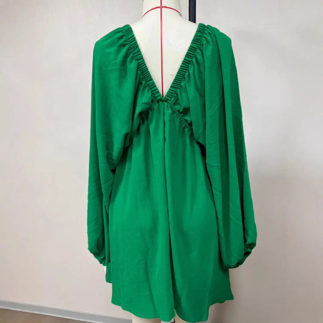 Women's apricot V-neck dress with long puff sleeves and a flounced swing skirt, mid-waist design.