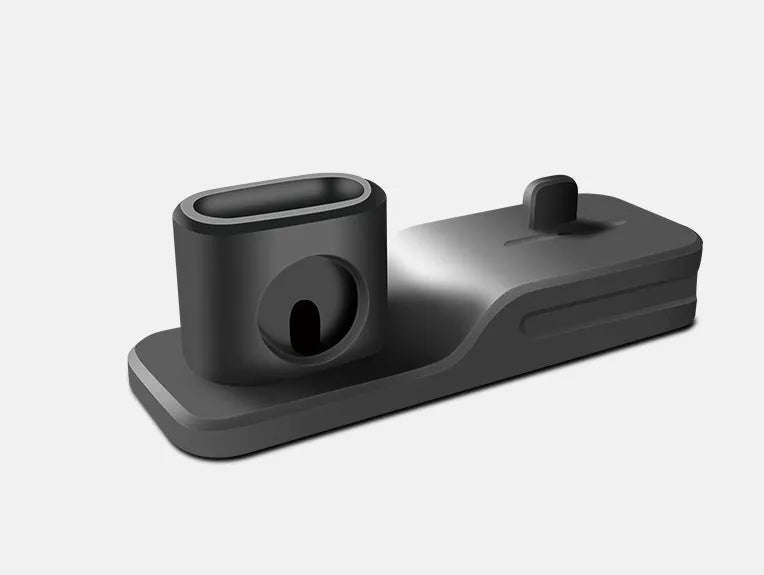 Black geometric 3-in-1 charging stand for Apple iPhone, Watch, and AirPods on a desk.