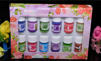 Box of 12 round plastic aromatherapy oil bottles, 25-50mL, featuring lemon, rose, jasmine, lavender floral scents