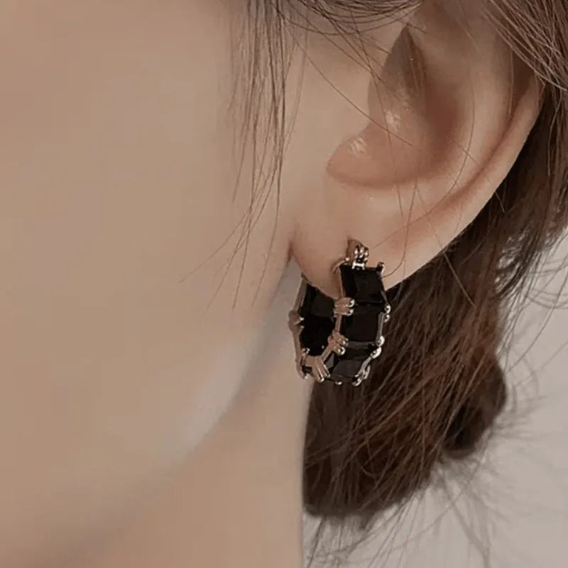 Geometric U-shaped gold electroplated earrings with round black zirconium stones
