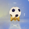 Football LED small night lamp with glass shade and remote control on a bedside table