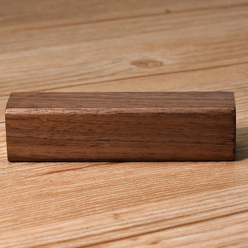 Black walnut wood portable power bank showing wooden casing with USB port and dimensions of 100mm x 25mm x 25mm