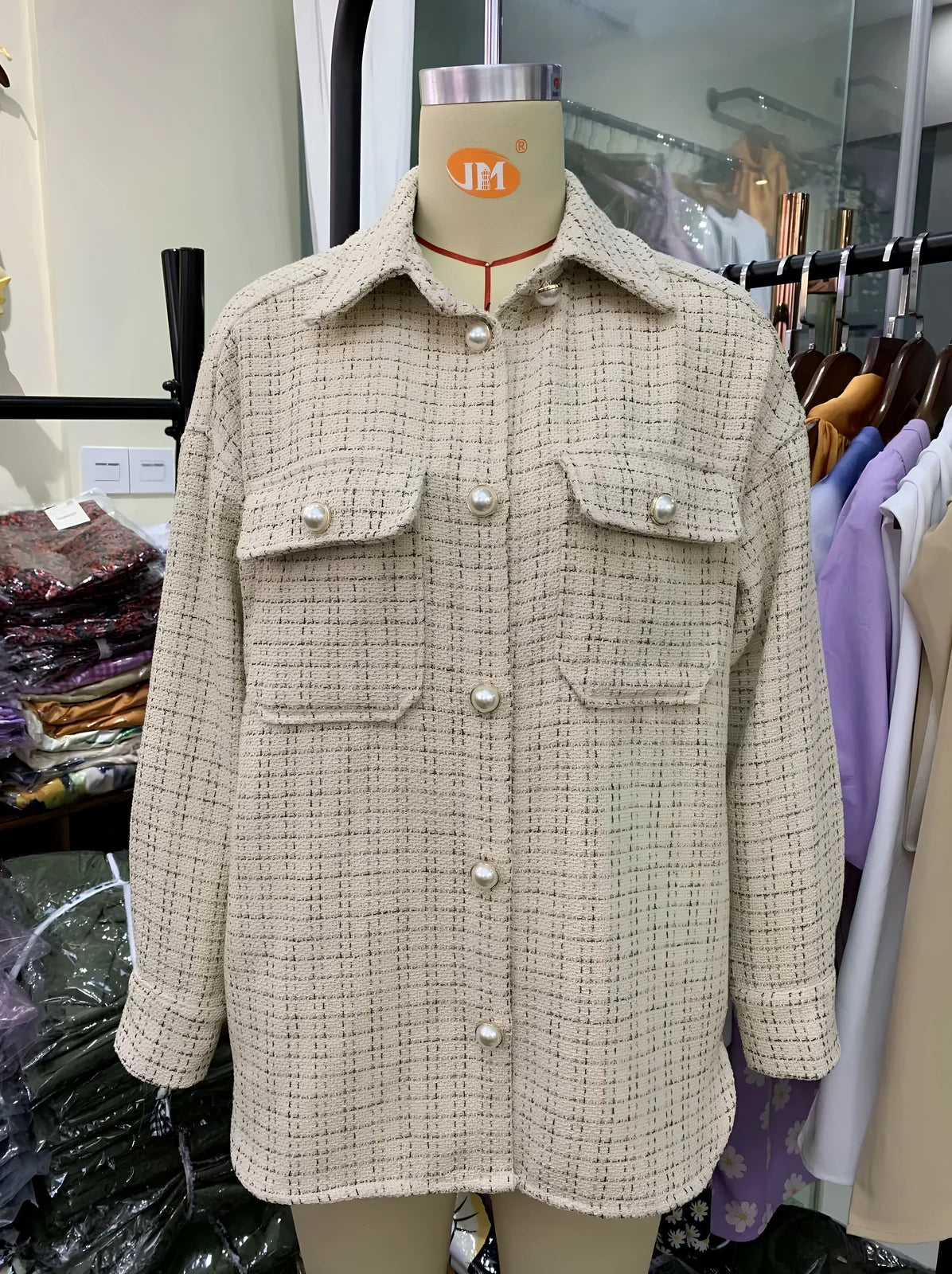 Women's beige plaid thick coat with pearl buttons, long sleeves, lapel collar, and side pockets in size M