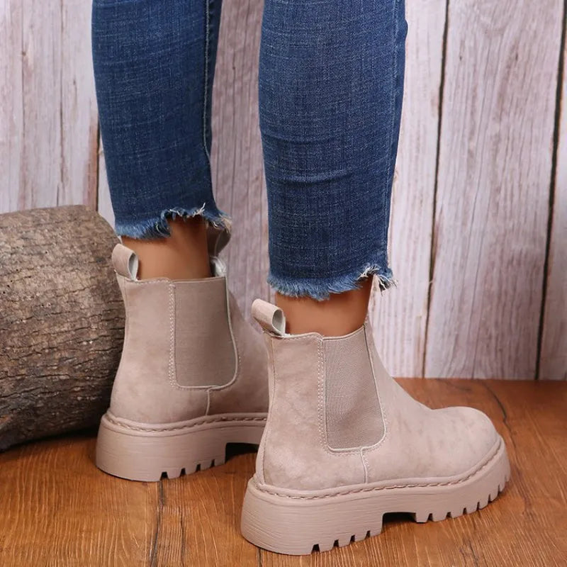 Women's Martin boots in solid colour with chunky platform sole, flat heel, and leather stitching