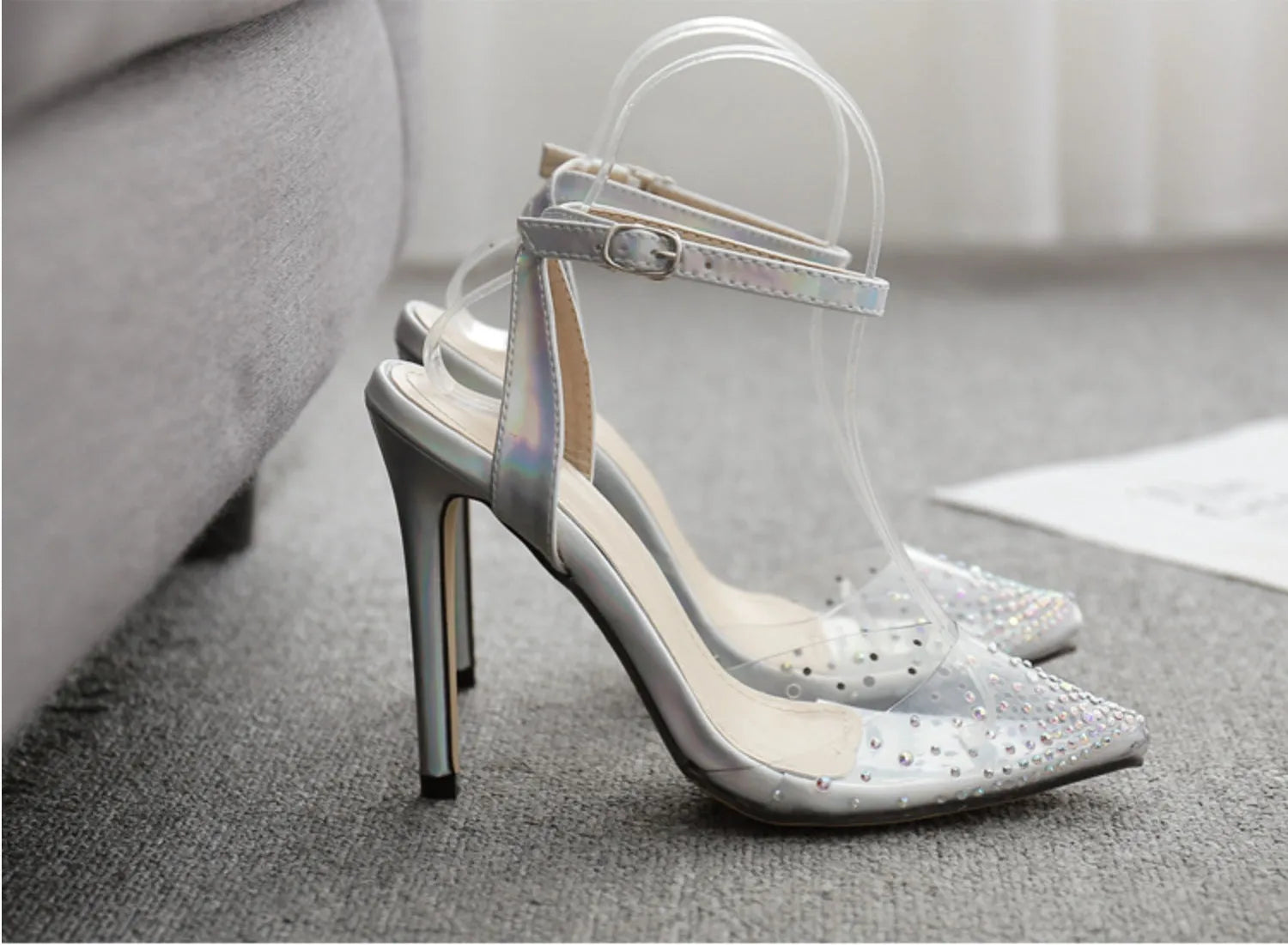 Women's pointed toe diamond embellished sandals with a stiletto heel on a white background.