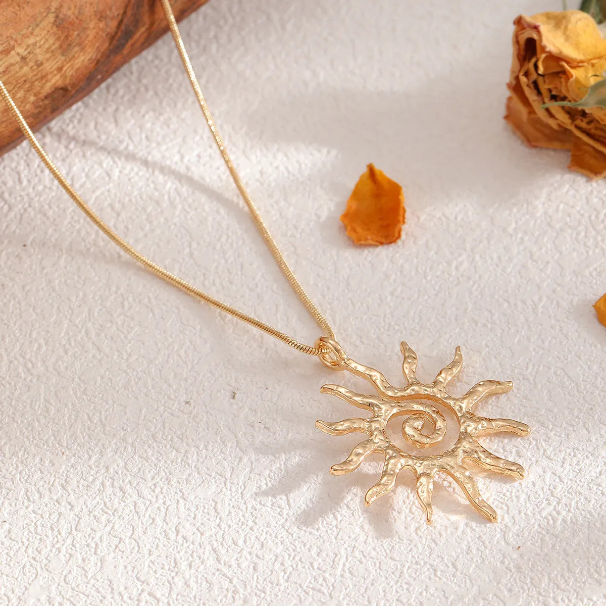 Gold sun hollow pendant necklace and earrings set with electroplated finish on zinc alloy