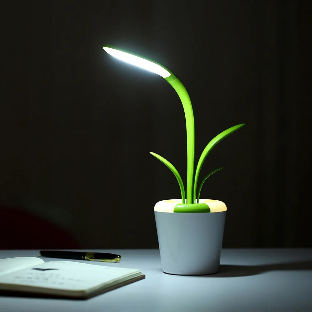 Modern rechargeable LED table lamp in pink with touch control and plant-shaped design on a wooden desk