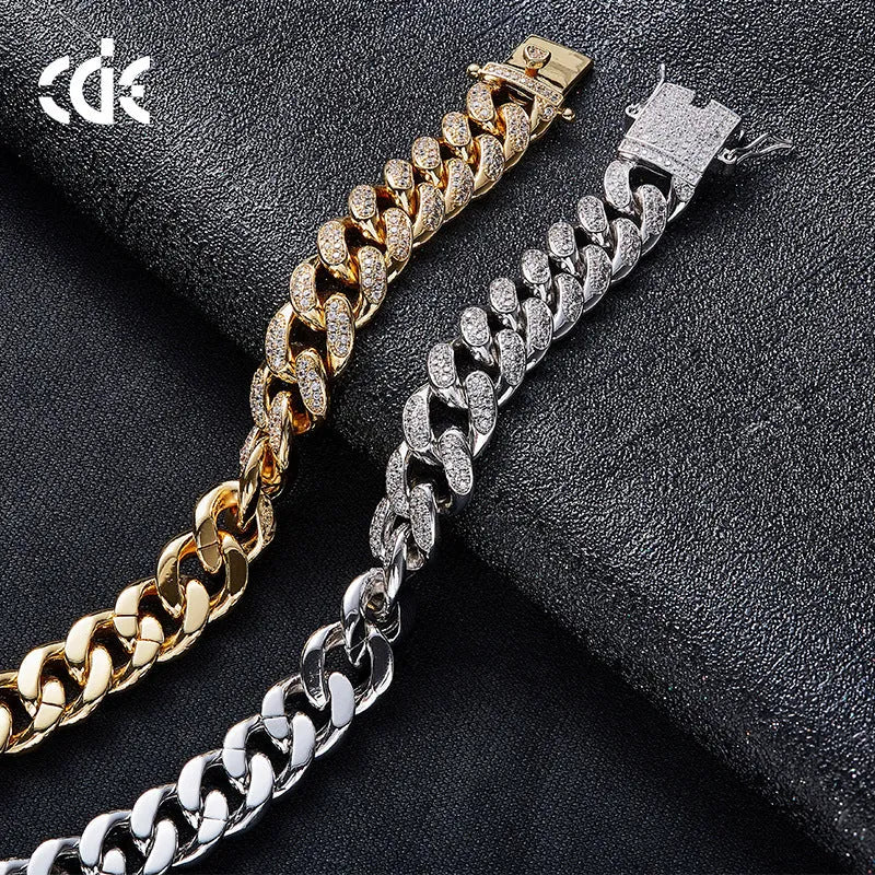 Men's Cuban chain bracelet with gold finish and geometric zircon pendant on a flat surface