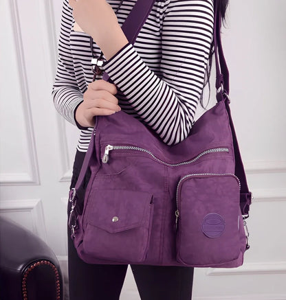 Women's waterproof nylon crossbody bag with organizational pockets and 34cm laptop capacity