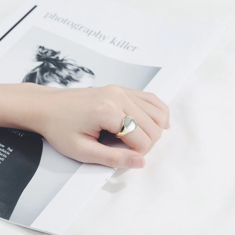 Adjustable oval smooth ring with polished electroplated finish in platinum and gold