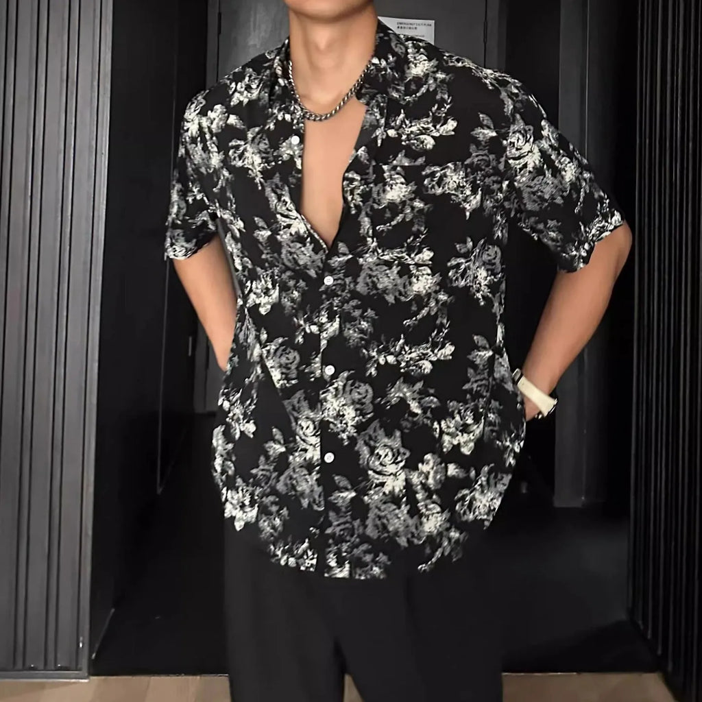 Men's loose-fit black short sleeve shirt with a white floral print pattern.