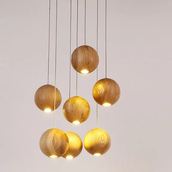 Nordic style solid wood ball chandelier hanging from a ceiling with an adjustable cord.