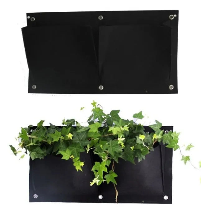 Vertical felt wall hanging planter with multiple planting pockets filled with green herbs.