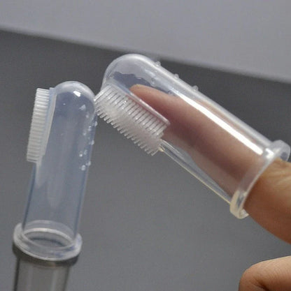 Silicone pet toothbrush set in white color, with finger-fit design for easy use and soft bristles for gentle cleaning of cats' and dogs' teeth.