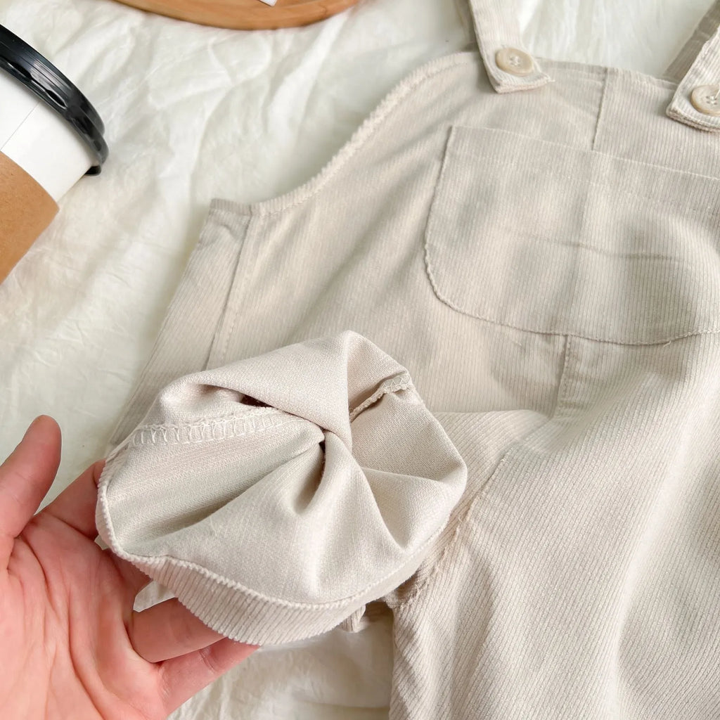 Infant plaid corduroy overalls in creamy-white with large pockets and double breasted closure