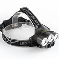 Fixed focus LED head torch with head strap, shown illuminating a long distance.