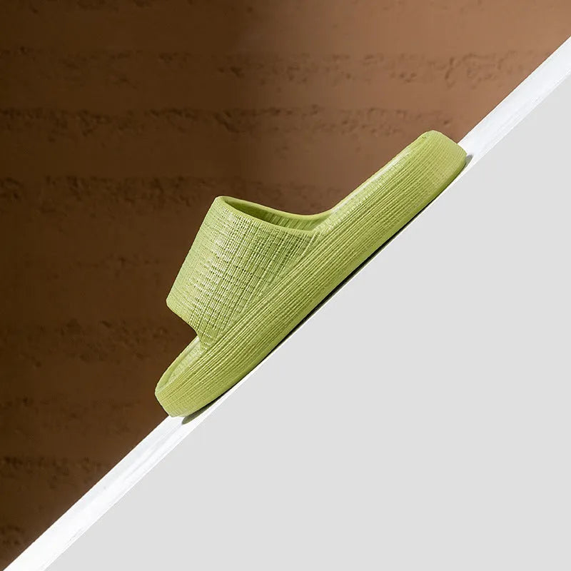 A pair of soft-bottom EVA bath slippers with a toe ring and non-slip sole, shown in one of five available colours.