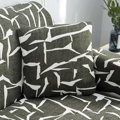 Printed stretchable sofa slipcover covering a three-seater sofa in a modern geometric pattern