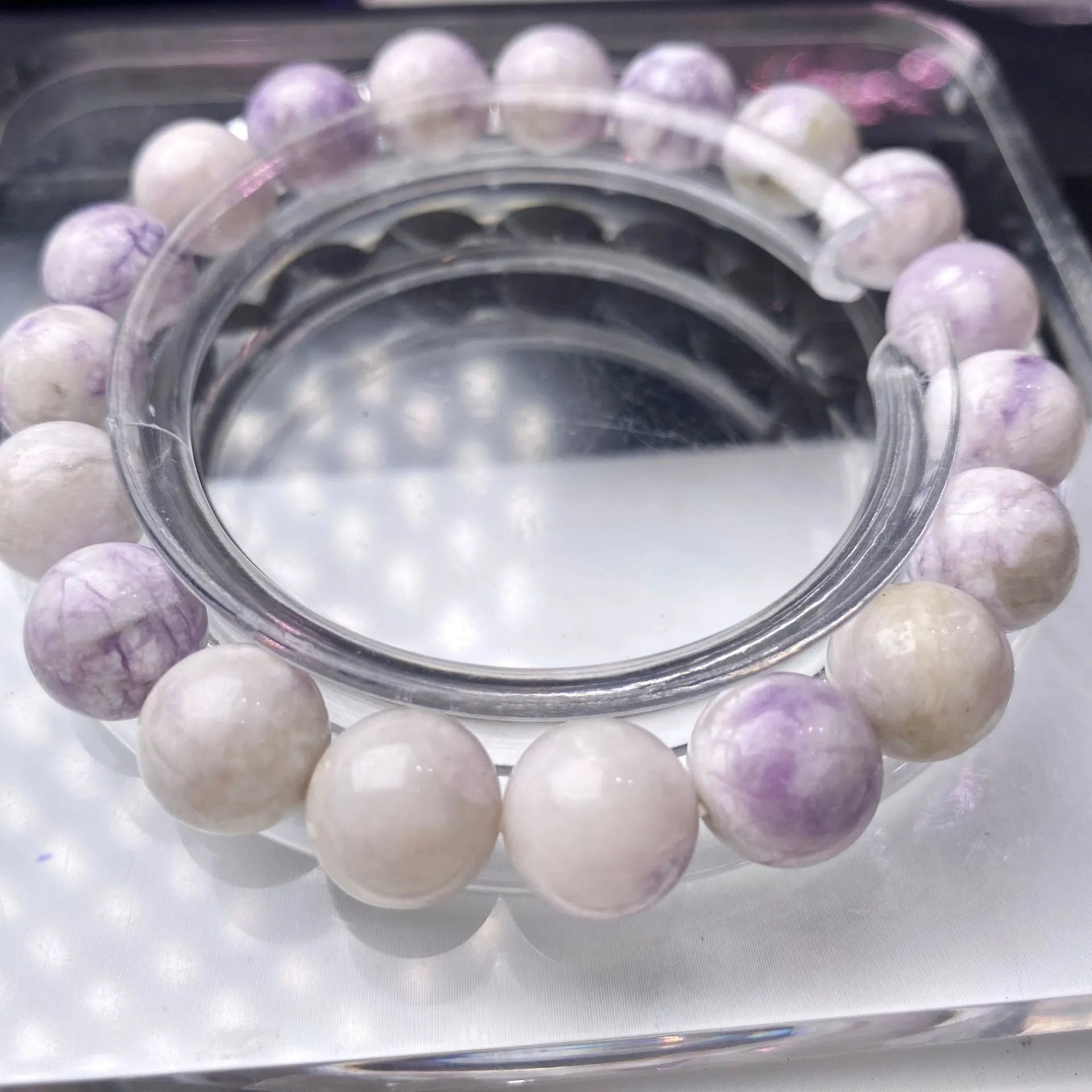 Women's purple turquoise bracelet with natural gemstone beads on a wrist.