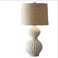 Ceramic base table lamp with a white fabric shade in an American simple country style.